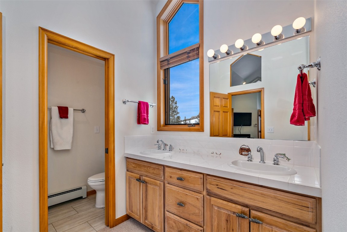 40 Nordic Trail Silverthorne, CO 80498 - Photo 23 of 35 a bathroom with a sink vanity and a mirror