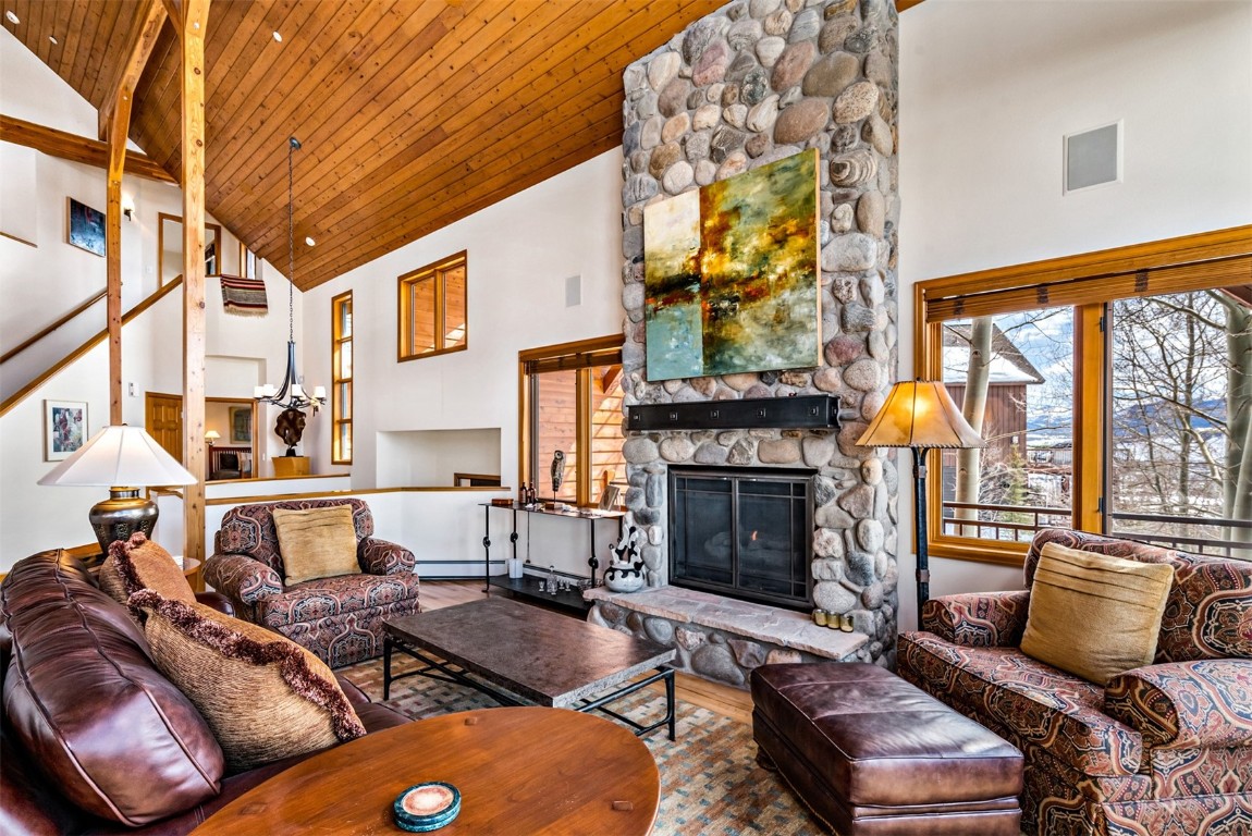 40 Nordic Trail Silverthorne, CO 80498 - Photo 5 of 35 a living room with furniture a fireplace and a floor to ceiling window
