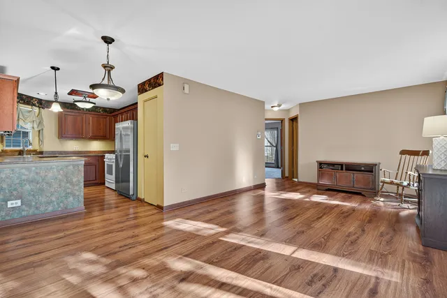 a view of a kitchen with furniture and wooden floor