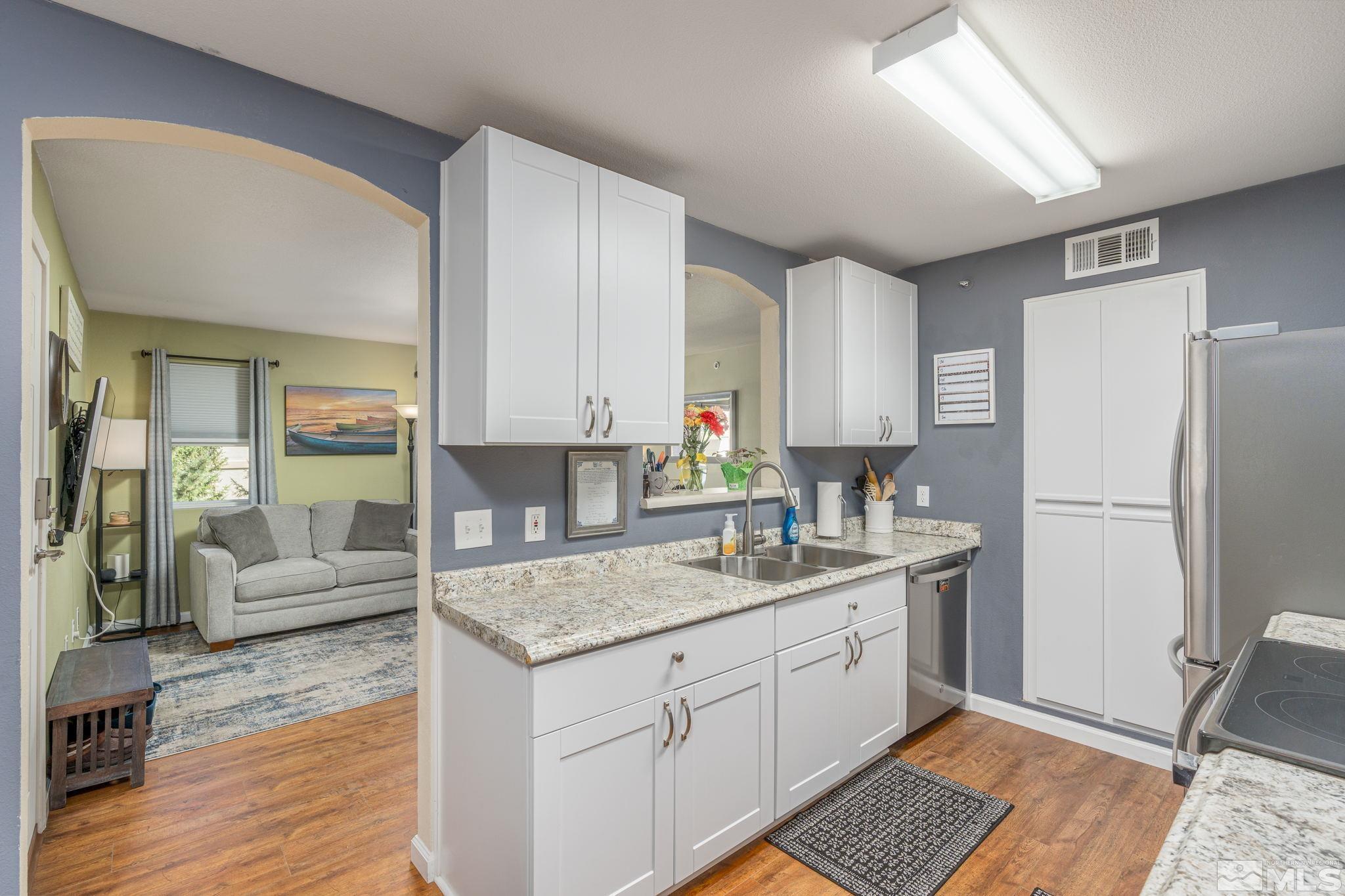 6850 Sharlands Avenue, Unit S2106 Reno, NV 89523 - Photo 17 of 36 a kitchen with a refrigerator sink and cabinets