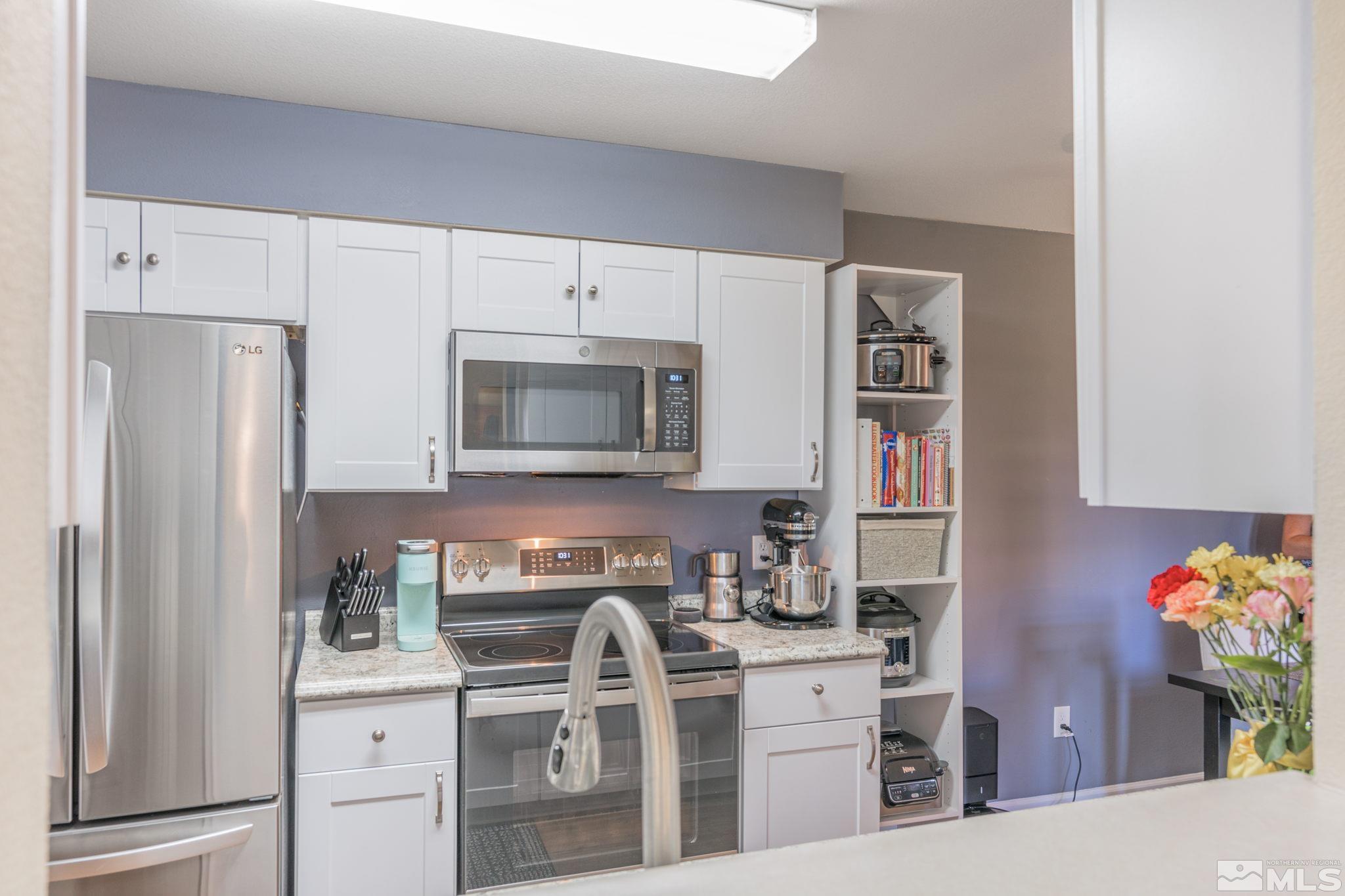 6850 Sharlands Avenue, Unit S2106 Reno, NV 89523 - Photo 18 of 36 a kitchen with stainless steel appliances a refrigerator sink and cabinets