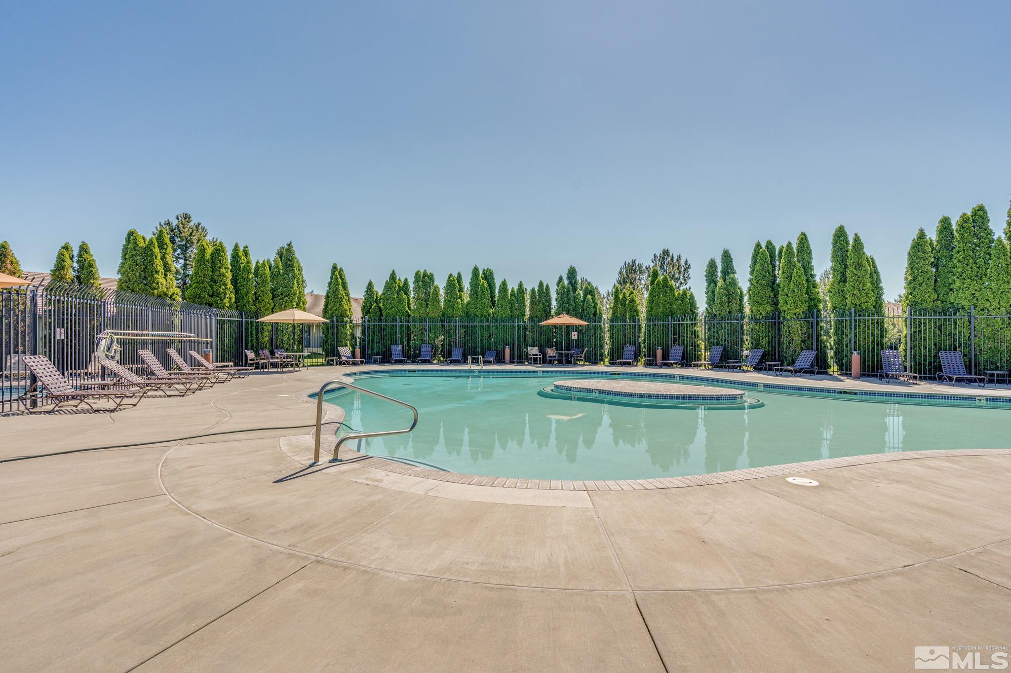 6850 Sharlands Avenue, Unit S2106 Reno, NV 89523 - Photo 27 of 36 a view of swimming pool with a yard and palm trees