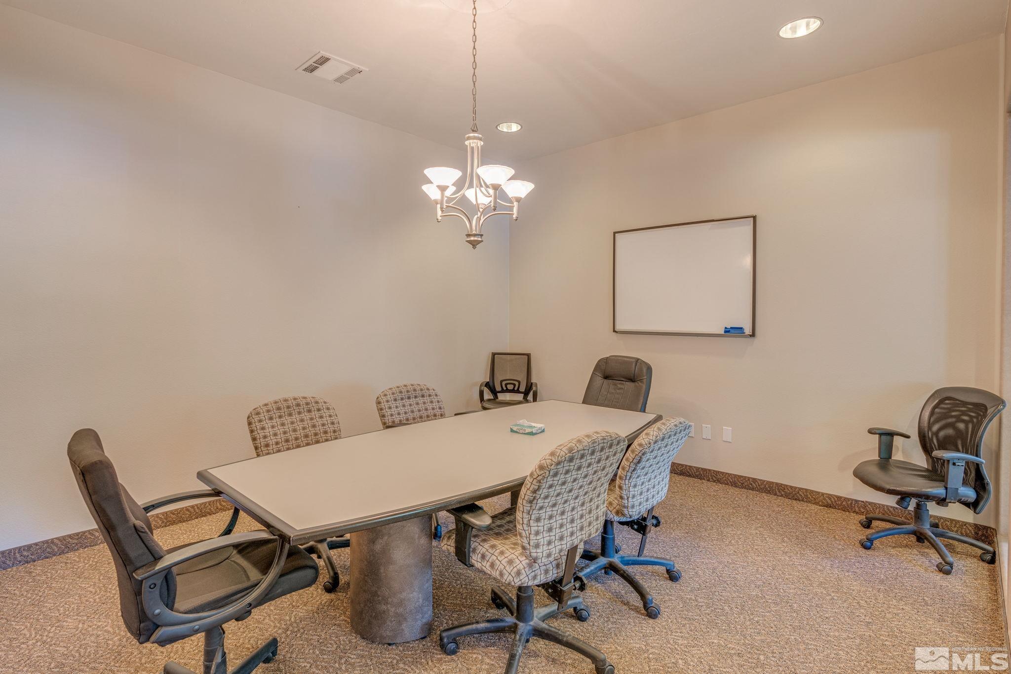 6850 Sharlands Avenue, Unit S2106 Reno, NV 89523 - Photo 33 of 36 a view of a dining room with furniture and chandelier