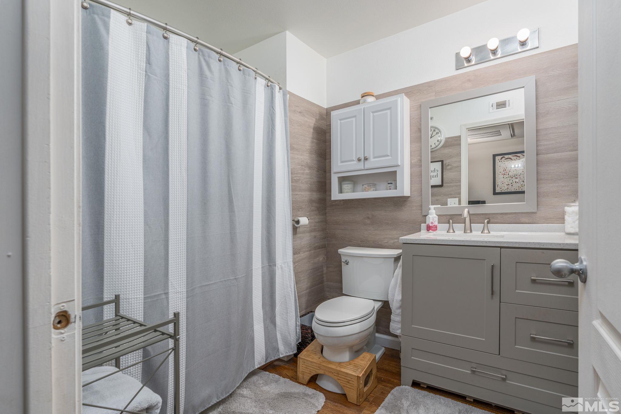 6850 Sharlands Avenue, Unit S2106 Reno, NV 89523 - Photo 8 of 36 a bathroom with a toilet sink and mirror