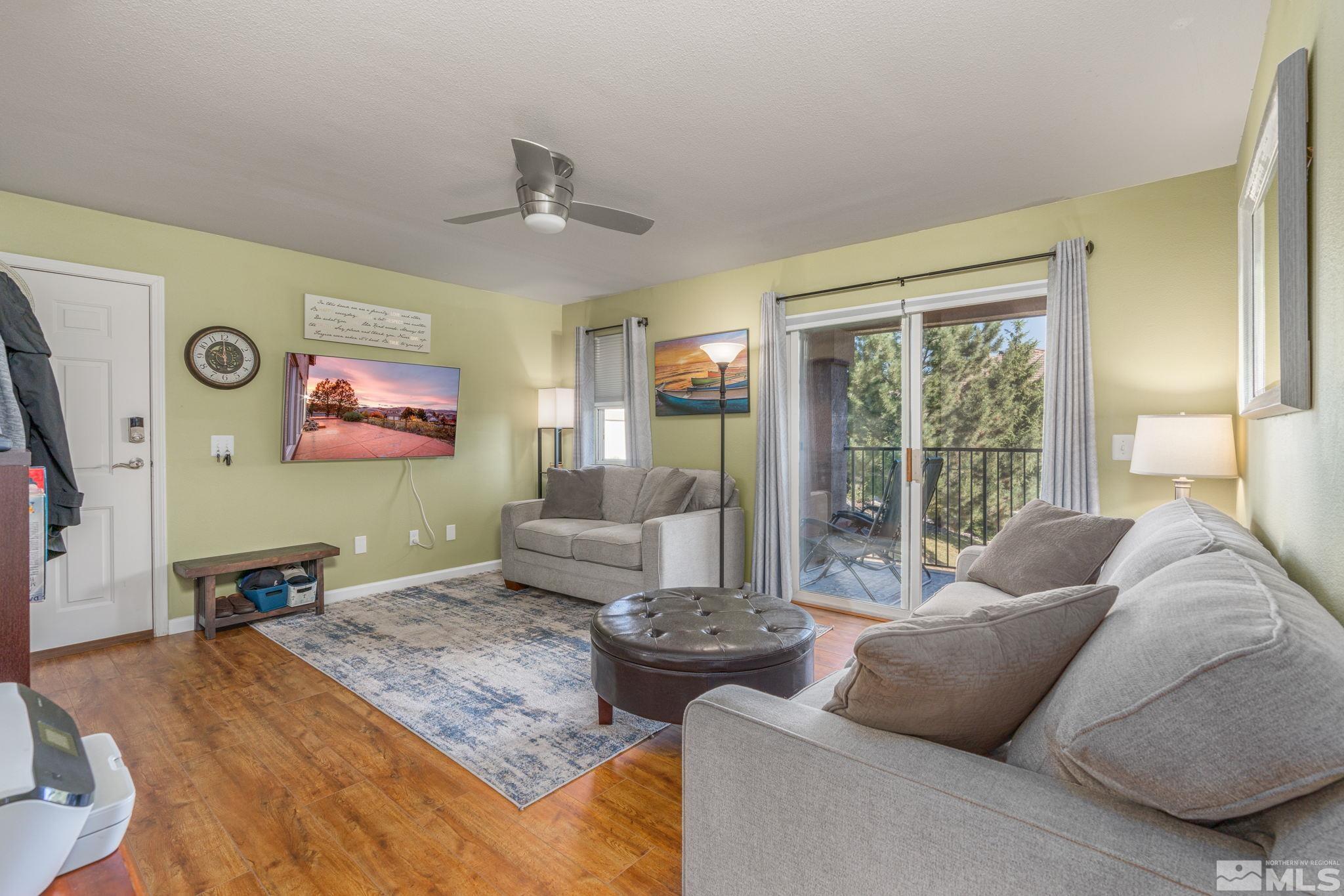 6850 Sharlands Avenue, Unit S2106 Reno, NV 89523 - Photo 10 of 36 a living room with furniture and a flat screen tv