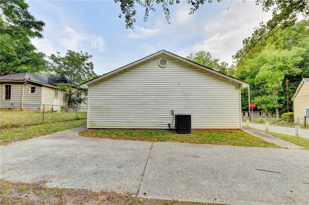 801 Davis Street Monroe, GA 30655 - Photo 32 of 33 a view of a house with a yard and garage
