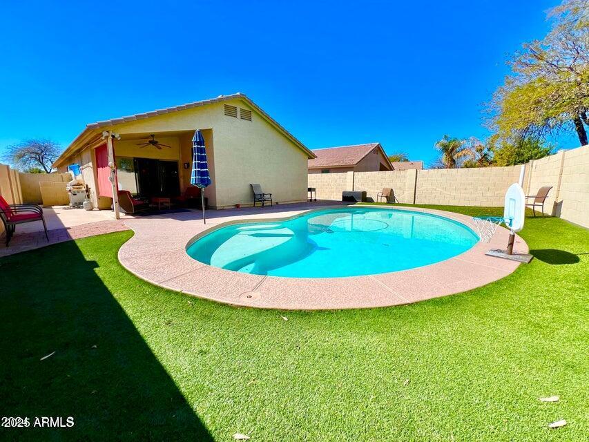a view of a house with a swimming pool and yard