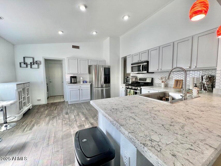 3410 East Escuda Road Phoenix, AZ 85050 - Photo 13 of 43 a kitchen with stainless steel appliances granite countertop a sink stove and refrigerator