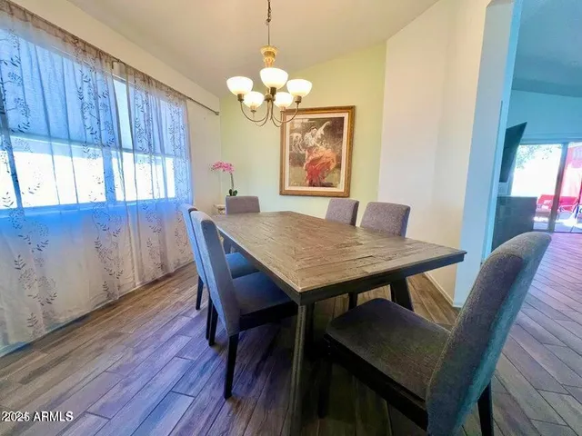 a view of a dining room with furniture and window
