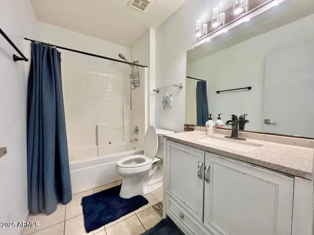 a bathroom with a sink toilet a mirror and shower