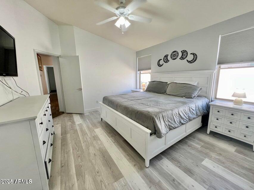 3410 East Escuda Road Phoenix, AZ 85050 - Photo 23 of 43 a bedroom with a bed and a flat tv screen on the dresser