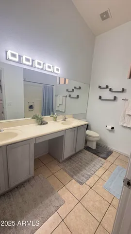 a bathroom with a double vanity sink and a mirror