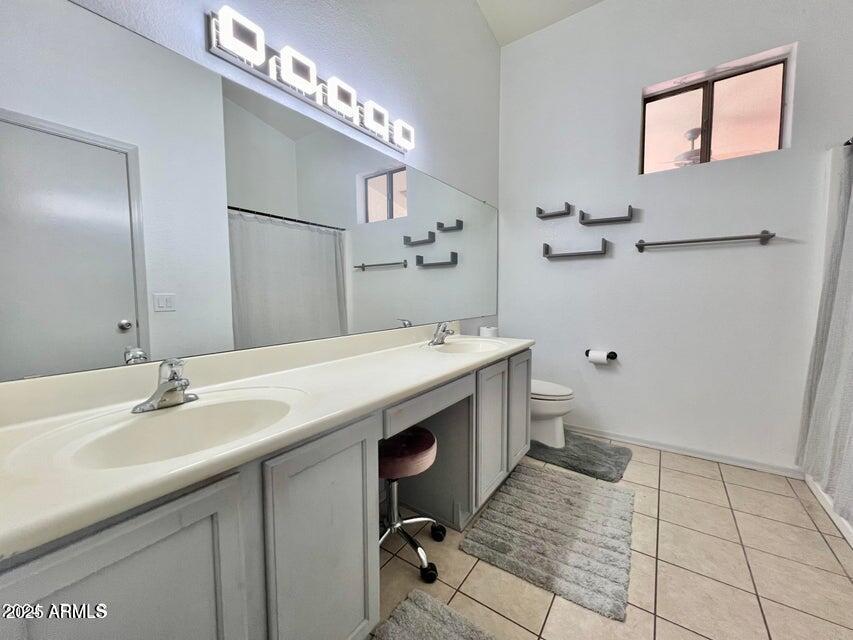 3410 East Escuda Road Phoenix, AZ 85050 - Photo 27 of 43 a bathroom with a sink a toilet and mirror