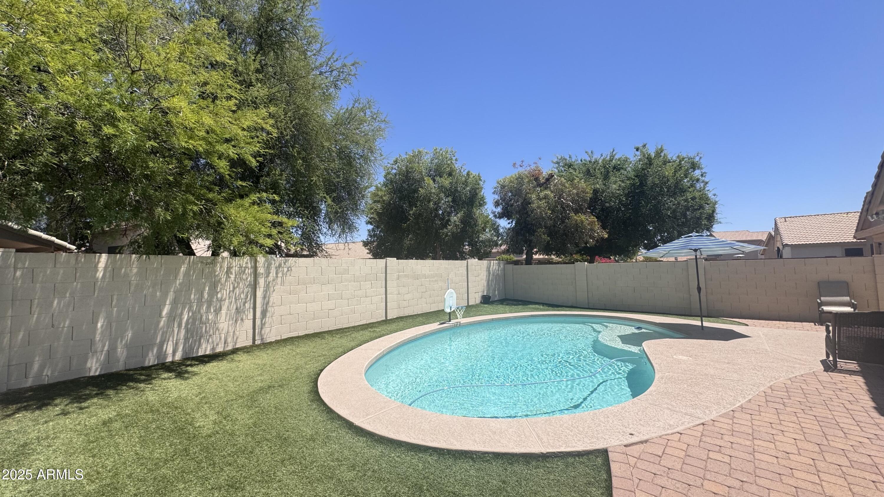 3410 East Escuda Road Phoenix, AZ 85050 - Photo 35 of 43 a view of a backyard with swimming pool and wooden fence