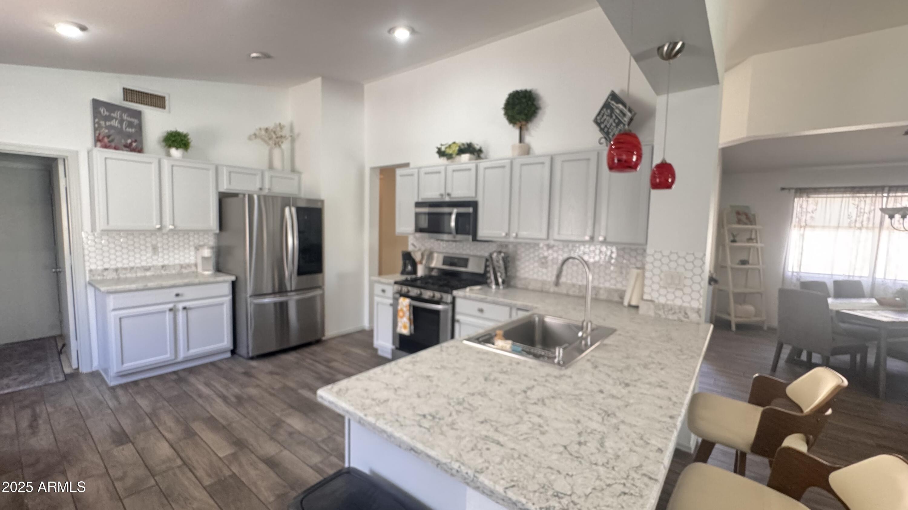 3410 East Escuda Road Phoenix, AZ 85050 - Photo 8 of 43 a kitchen with stainless steel appliances granite countertop a refrigerator sink and cabinets