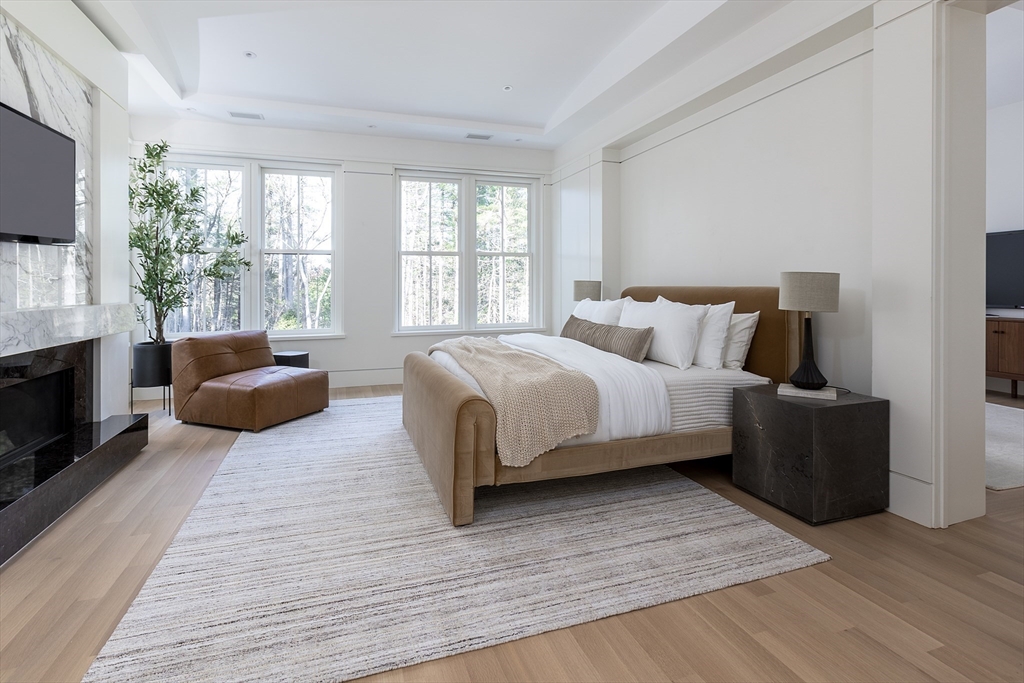 21 Chestnut Street Weston, MA 02493 - Photo 15 of 34 a bedroom with a bed a couch and large window