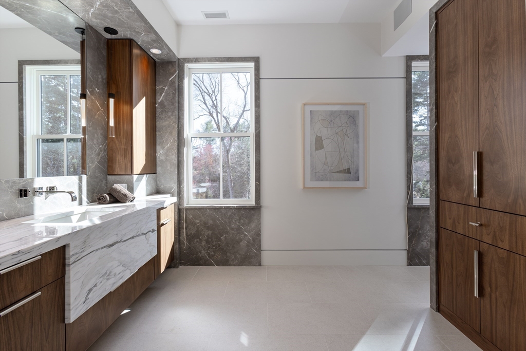21 Chestnut Street Weston, MA 02493 - Photo 17 of 34 a bathroom with a double vanity sink and mirror with bathtub