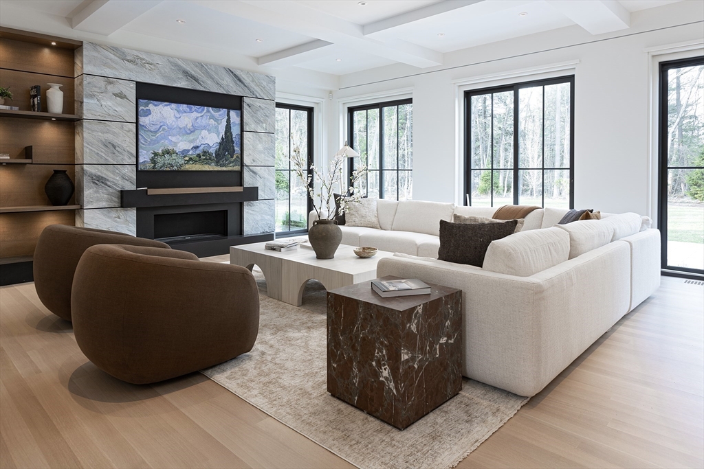 21 Chestnut Street Weston, MA 02493 - Photo 2 of 34 a living room with furniture a fireplace and a large window