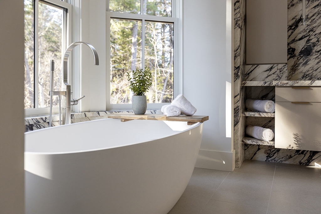 21 Chestnut Street Weston, MA 02493 - Photo 24 of 34 a spacious bedroom with a bed and a window