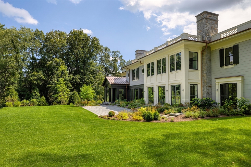 21 Chestnut Street Weston, MA 02493 - Photo 34 of 34 a front view of a house with a yard table and chairs