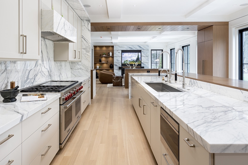 21 Chestnut Street Weston, MA 02493 - Photo 5 of 34 a large kitchen with stainless steel appliances granite countertop a lot of counter space and wooden floors
