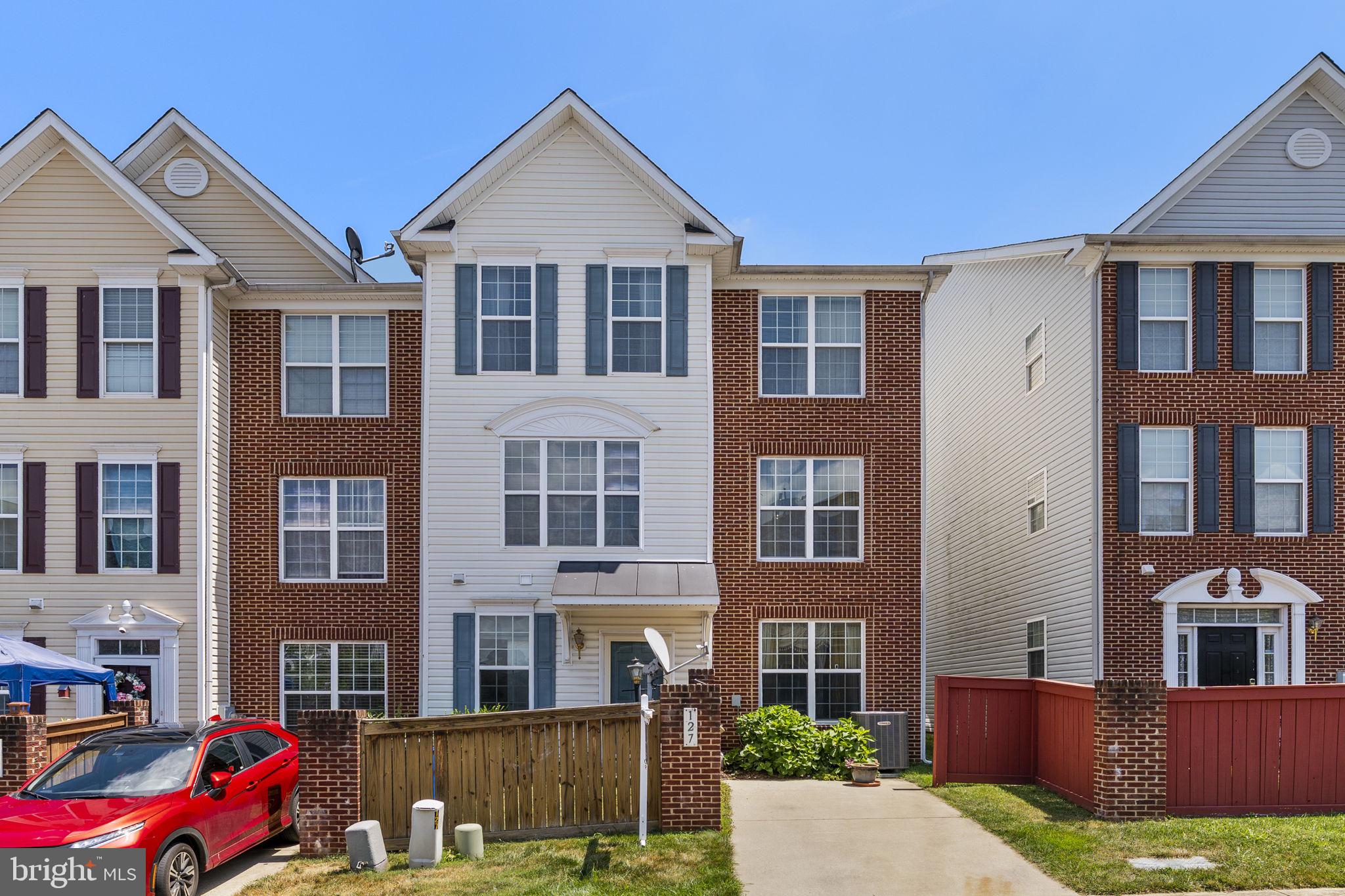 a front view of a residential apartment building with a yard