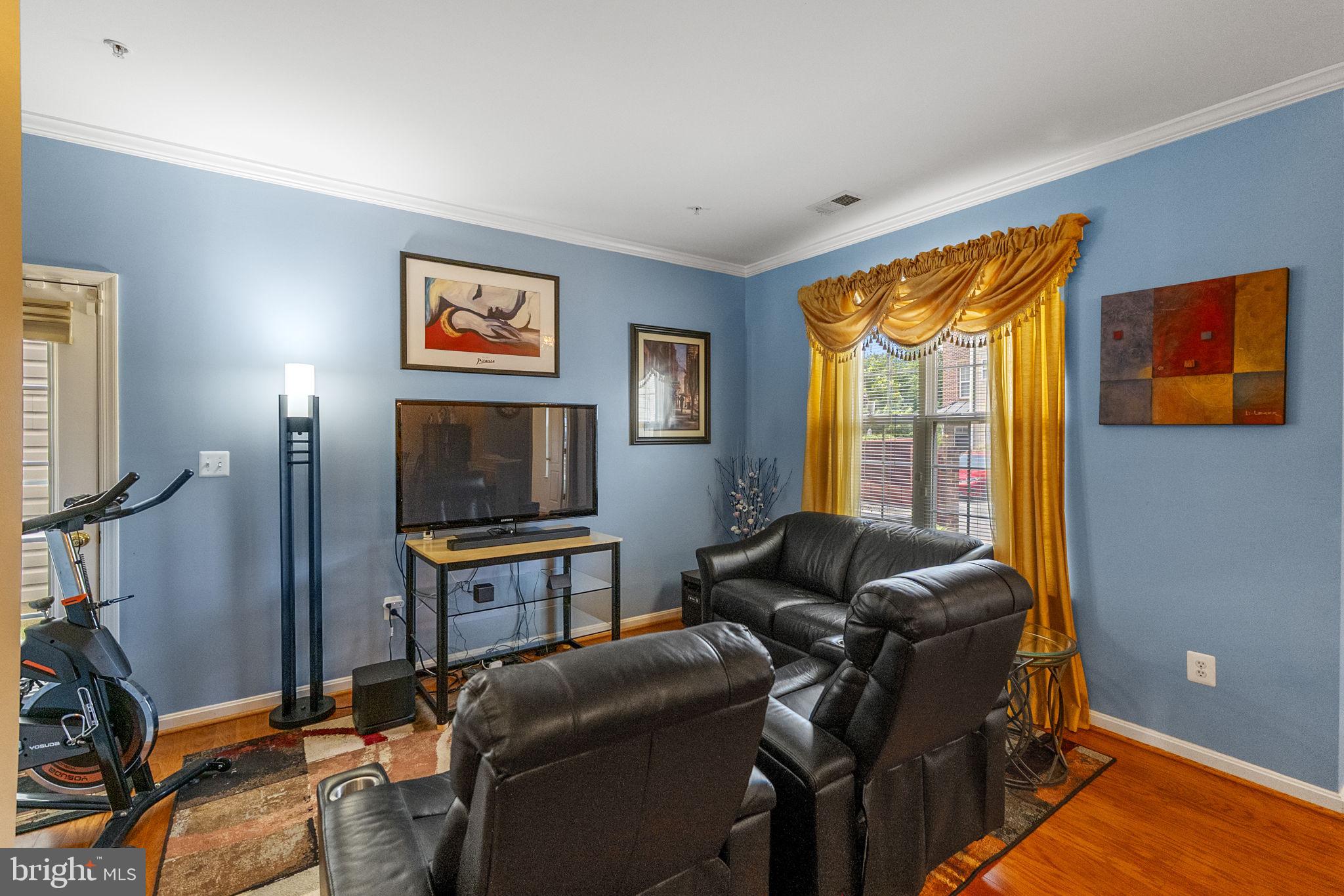 127 Mountain Creek Circle Frederick, MD 21702 - Photo 12 of 26 a living room with furniture a flat screen tv and a window