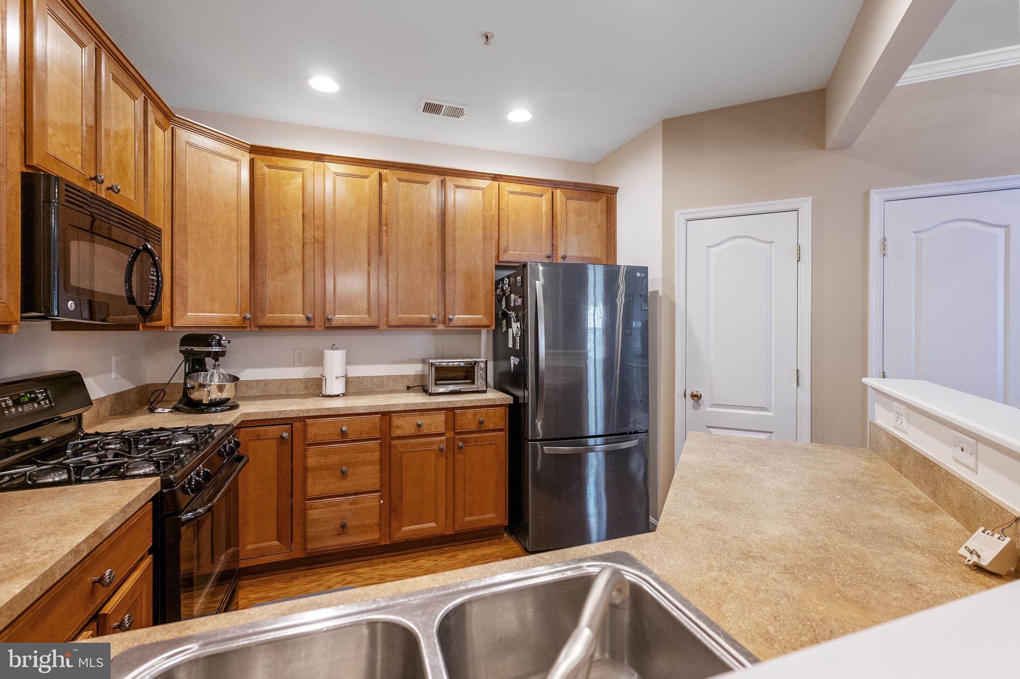 127 Mountain Creek Circle Frederick, MD 21702 - Photo 2 of 26 a kitchen with stainless steel appliances granite countertop a refrigerator stove and sink