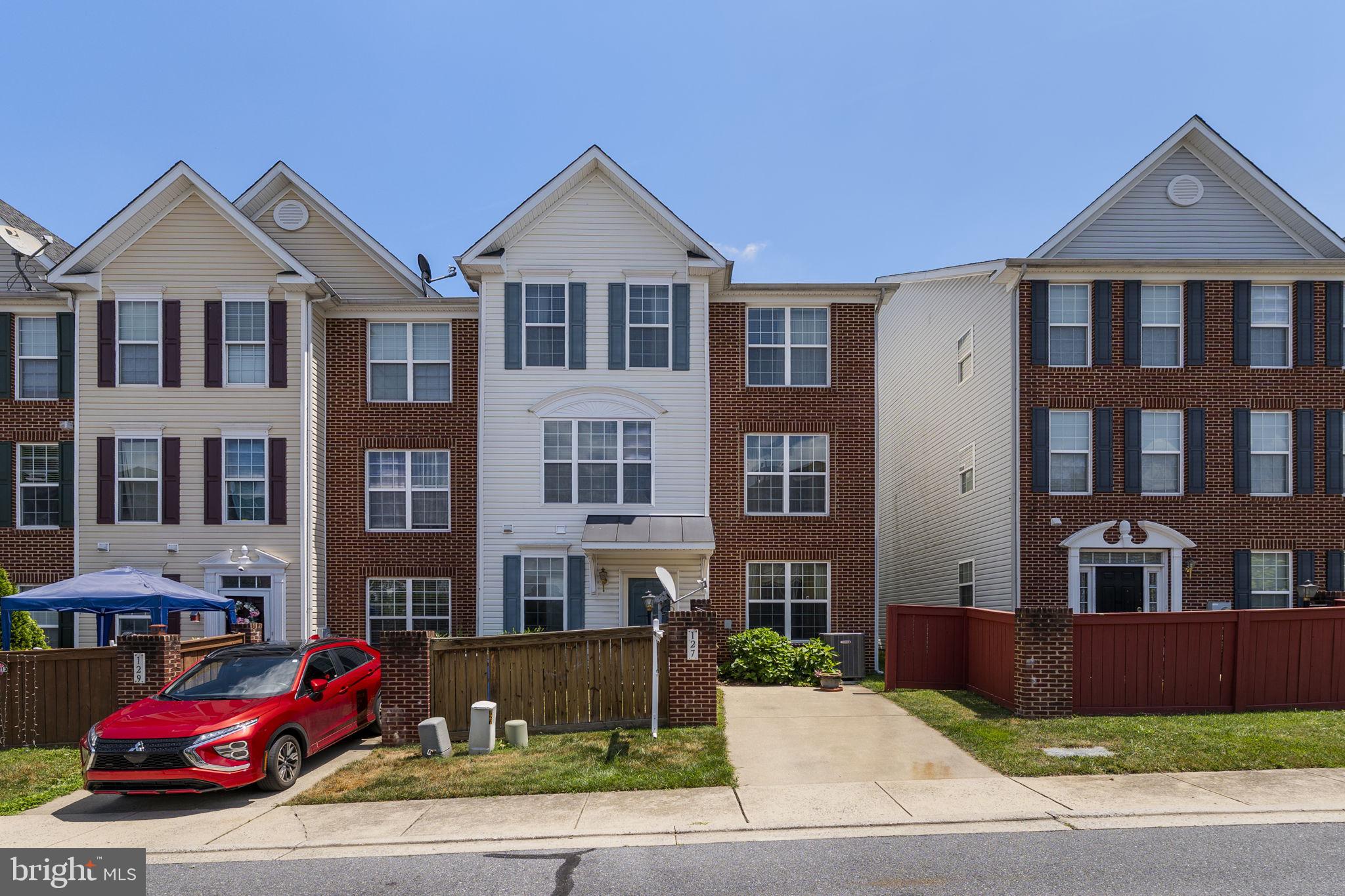 127 Mountain Creek Circle Frederick, MD 21702 - Photo 25 of 26 a front view of a residential apartment building with a yard