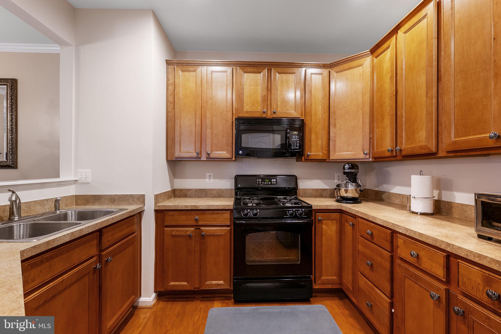127 Mountain Creek Circle Frederick, MD 21702 - Photo 4 of 26 a kitchen with stainless steel appliances granite countertop white cabinets granite counter tops and a window