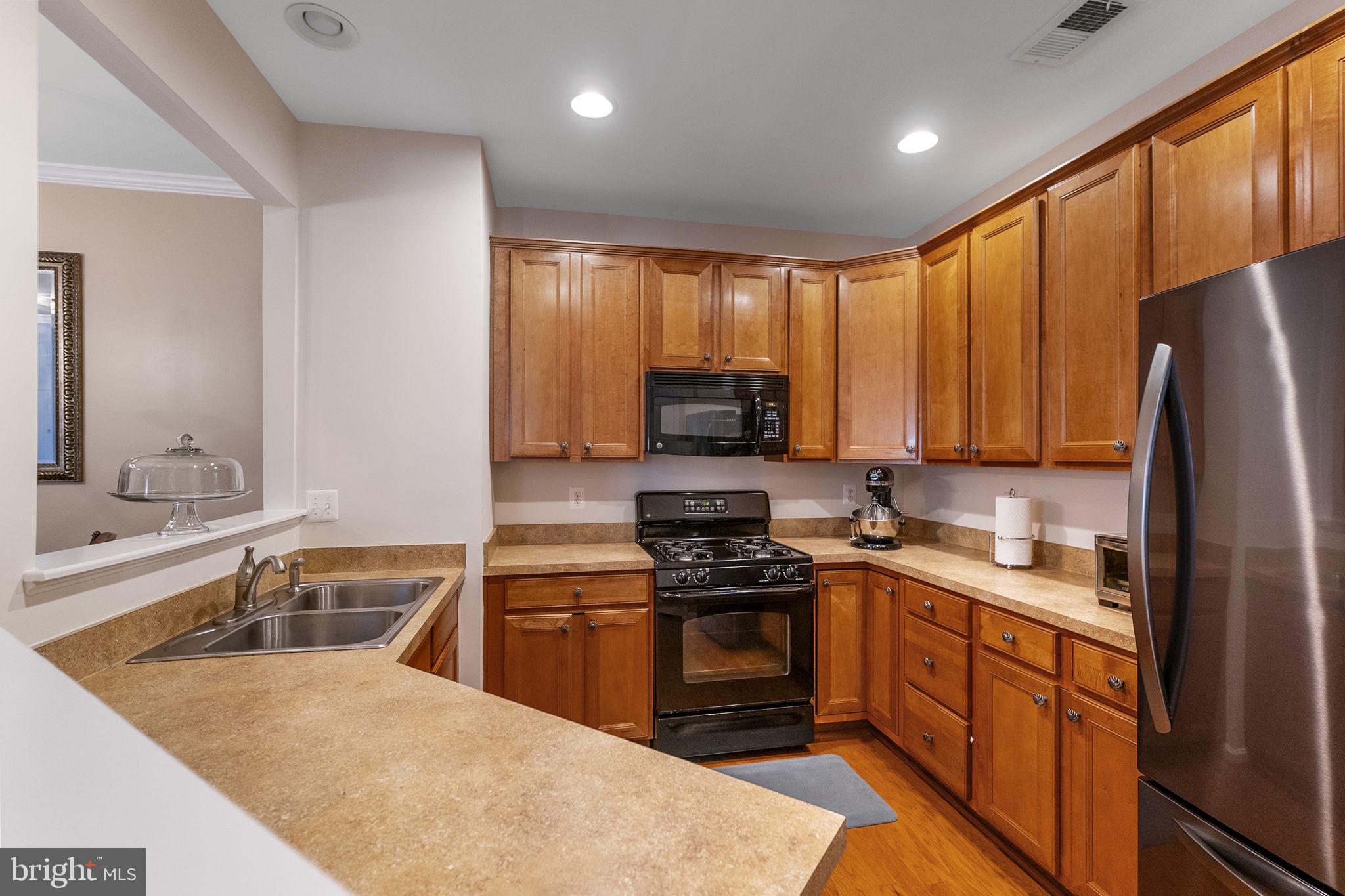 127 Mountain Creek Circle Frederick, MD 21702 - Photo 6 of 26 a kitchen with stainless steel appliances granite countertop a sink stove and refrigerator