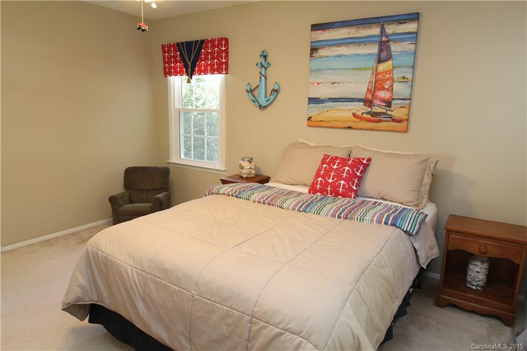 633 Neill Ridge Road Matthews, NC 28105 - Photo 14 of 24 a bedroom with bed and wall painting with wooden floor