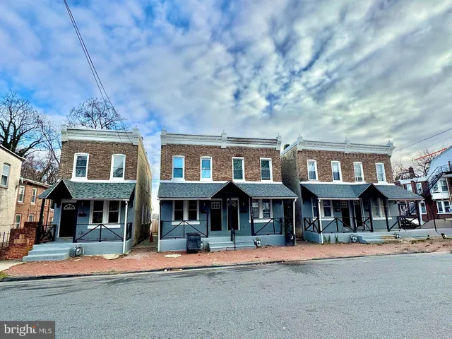 a front view of a brick building with many windows