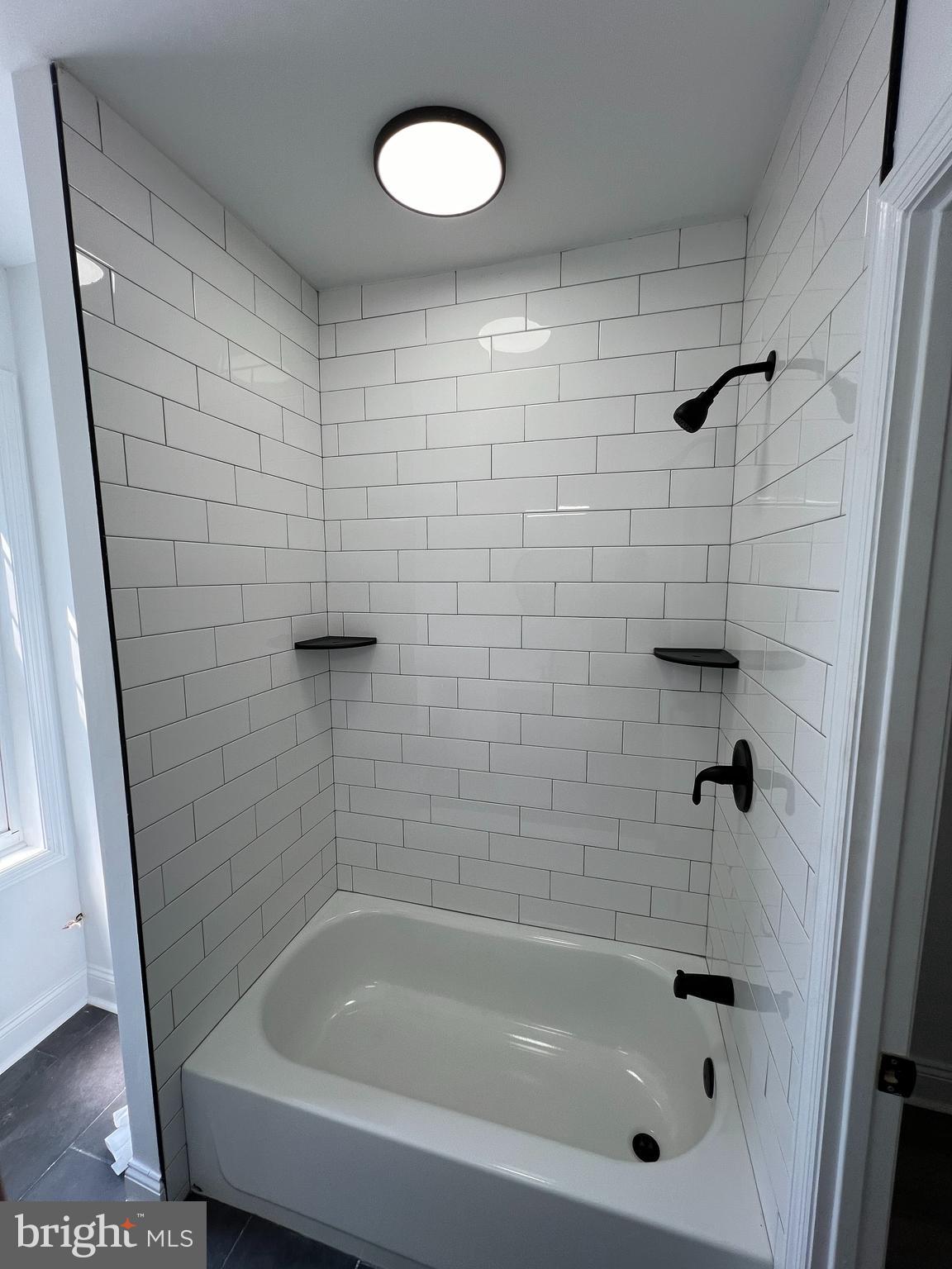 921 West 3rd Street Chester, PA 19013 - Photo 17 of 18 a bathroom with a shower and a bathtub