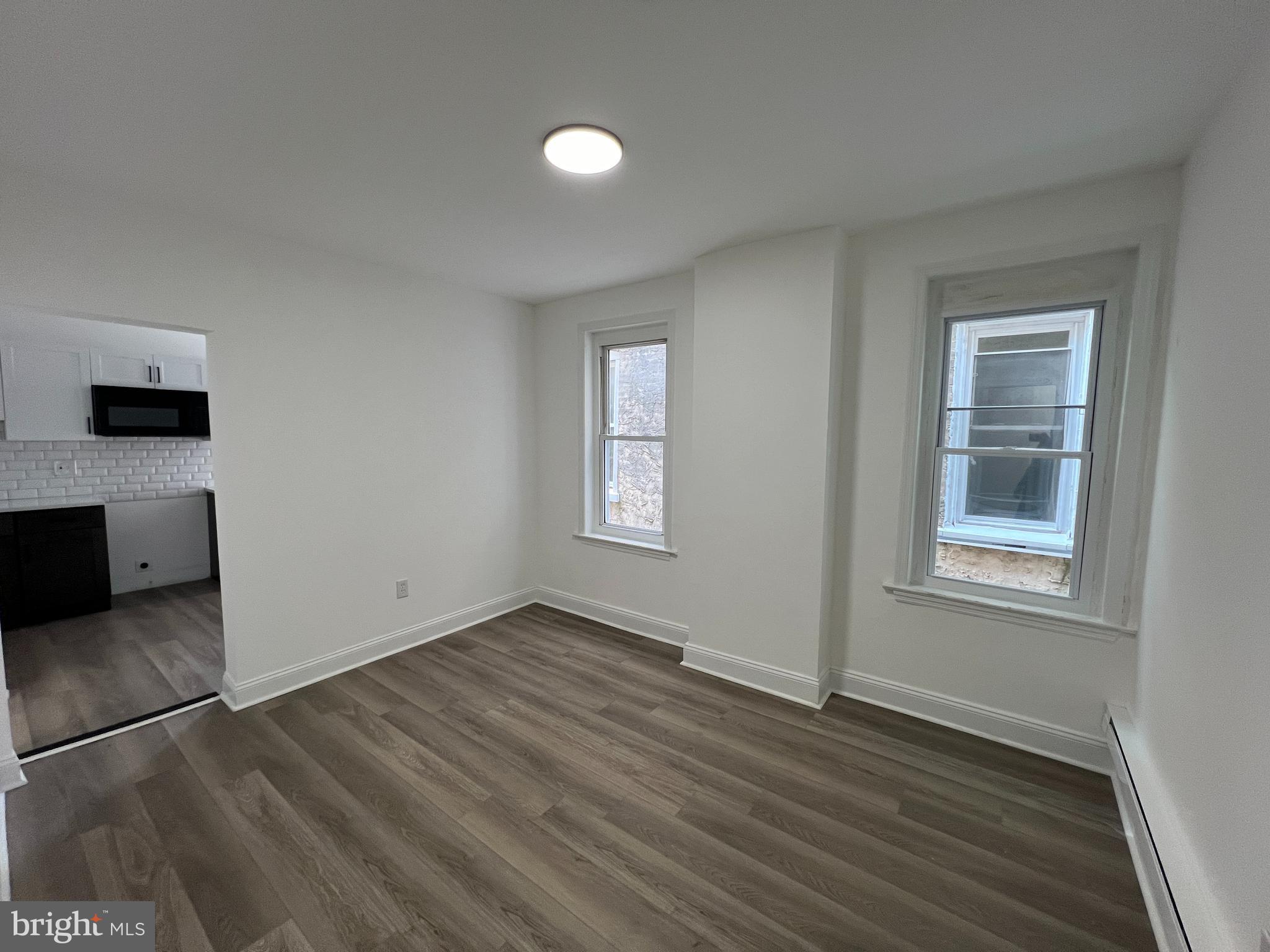 921 West 3rd Street Chester, PA 19013 - Photo 7 of 18 an empty room with wooden floor and windows