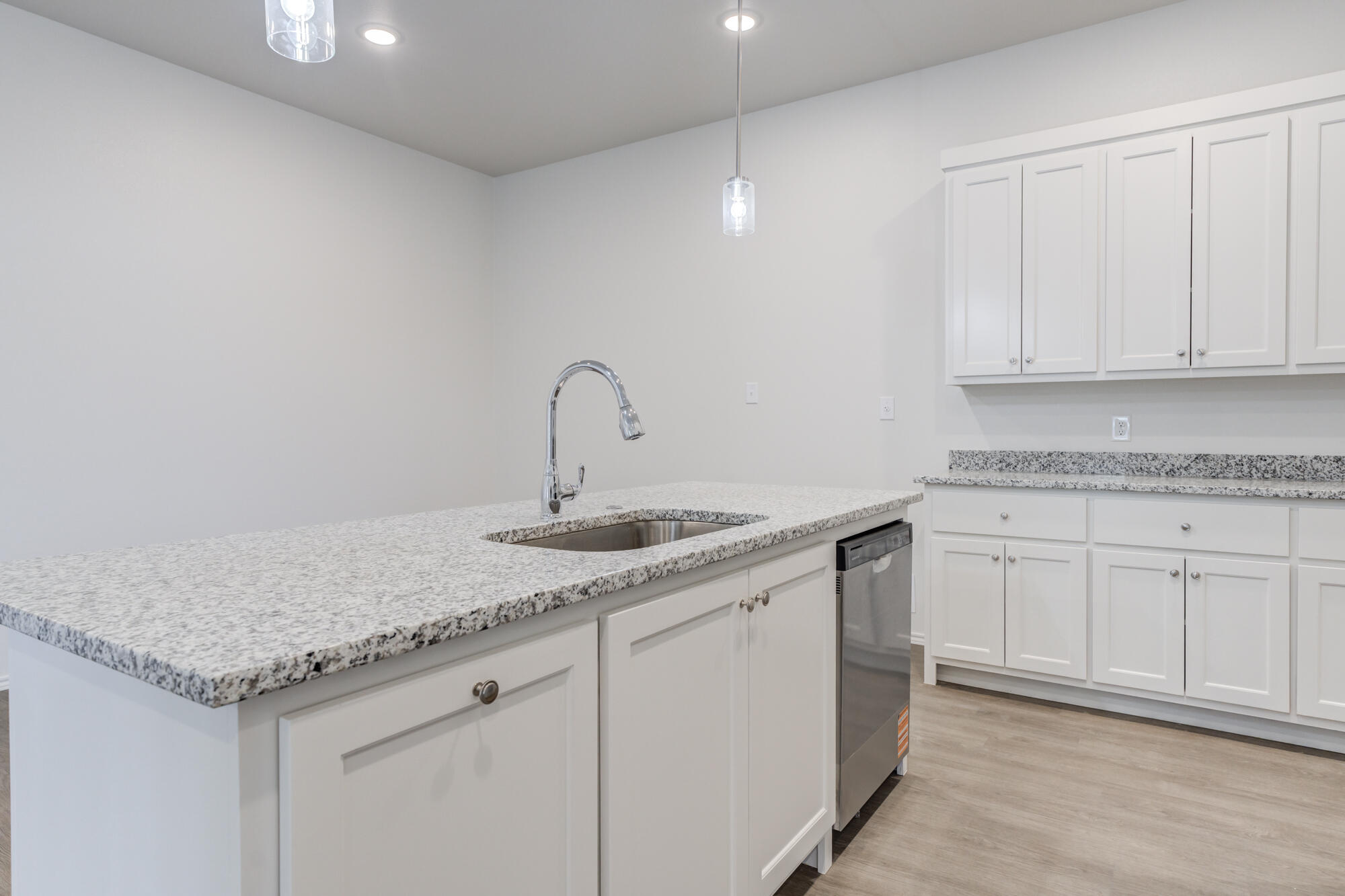 7007 40th Street Lubbock, TX 79407 - Photo 12 of 30 a kitchen with granite countertop white cabinets and a sink