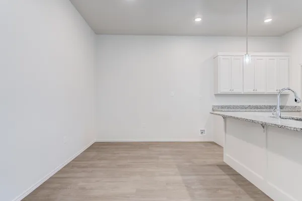 a view of a kitchen with a sink and cabinets