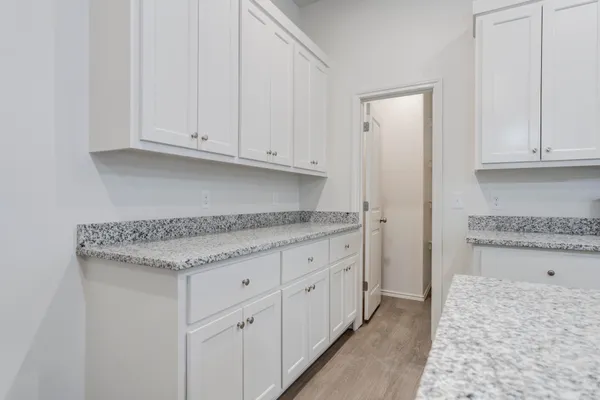a kitchen with granite countertop white cabinets and a granite counter tops
