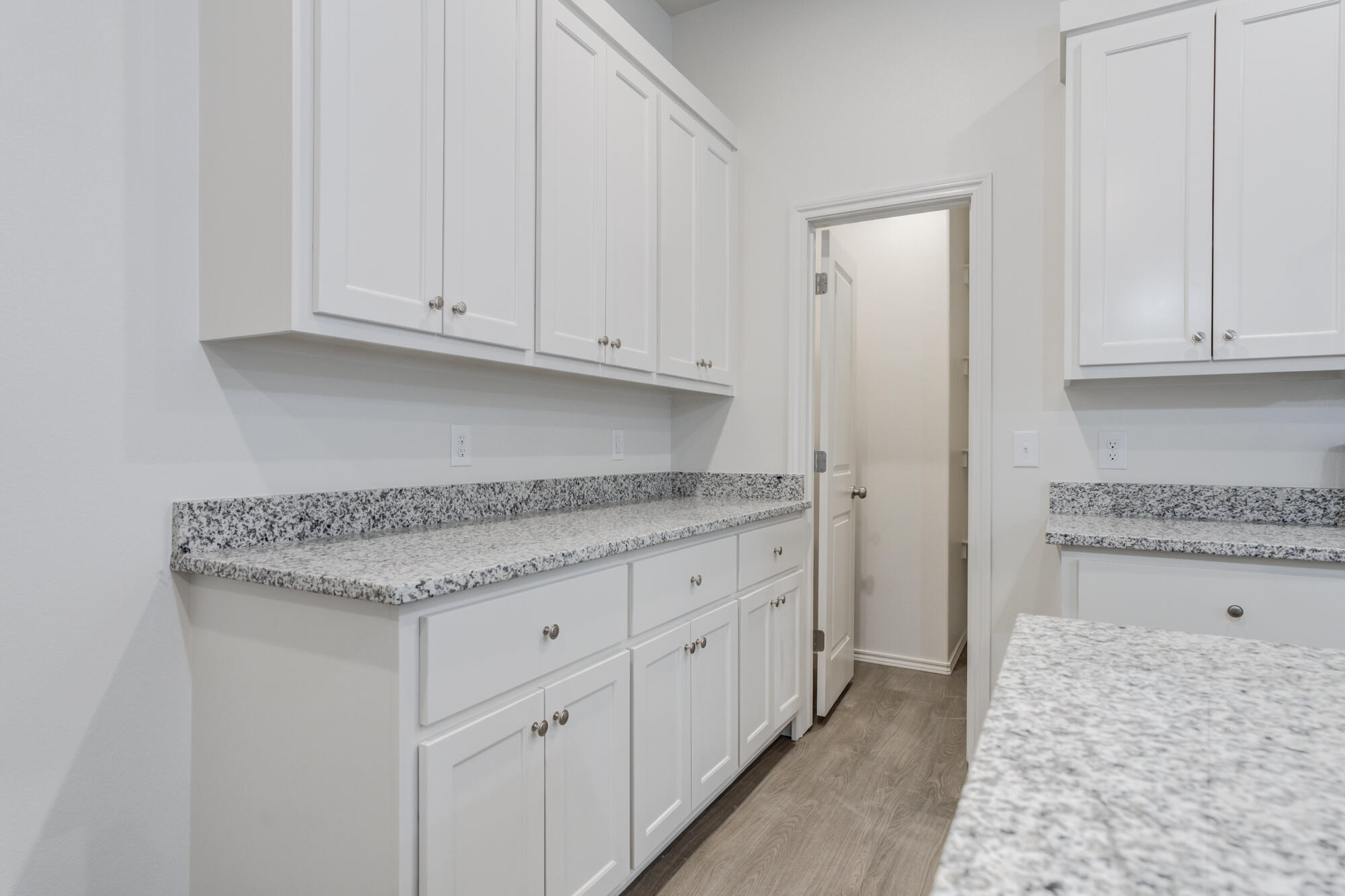 7007 40th Street Lubbock, TX 79407 - Photo 15 of 30 a kitchen with granite countertop white cabinets and a granite counter tops