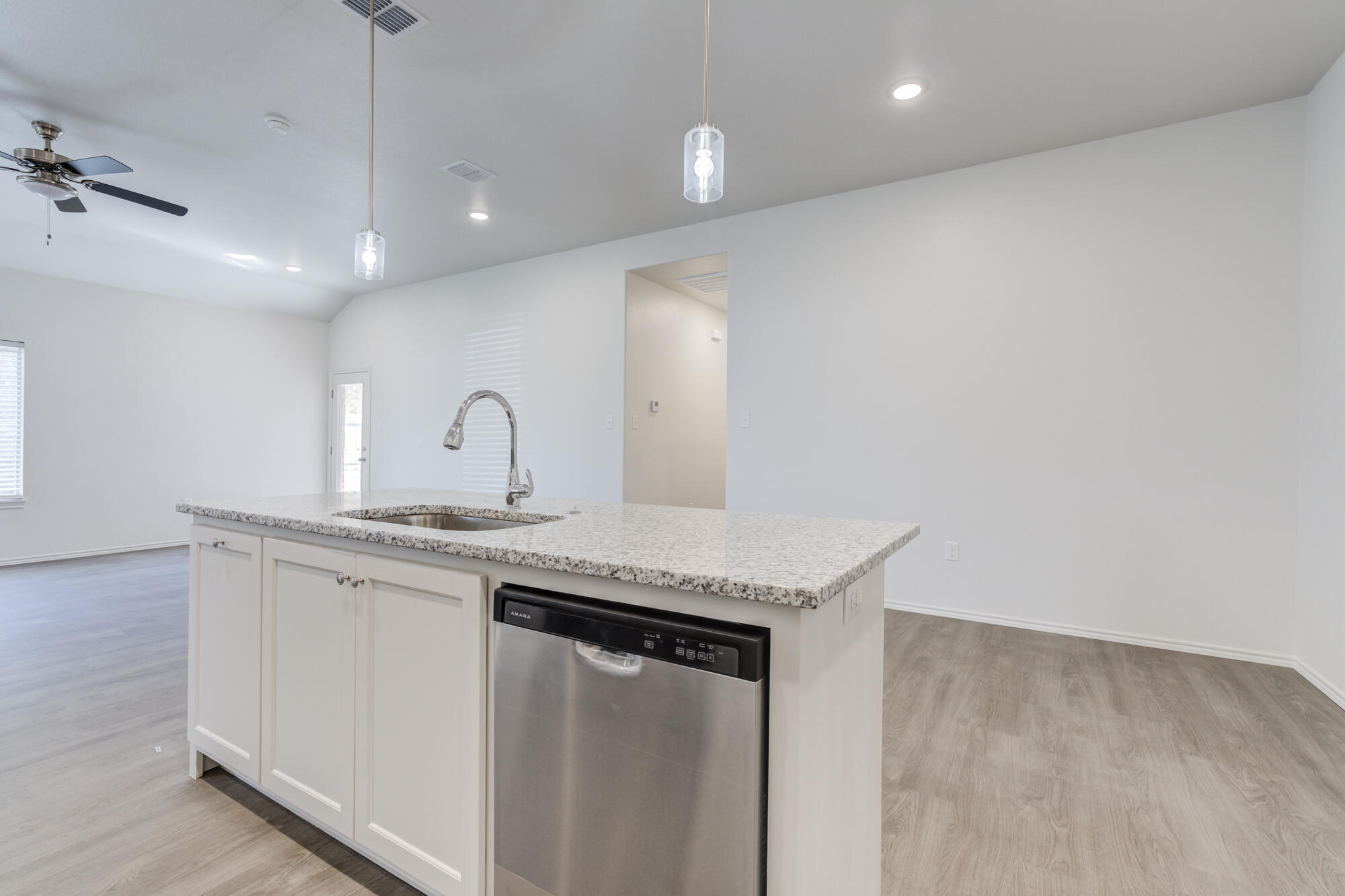 7007 40th Street Lubbock, TX 79407 - Photo 18 of 30 a kitchen with granite countertop a sink and cabinets