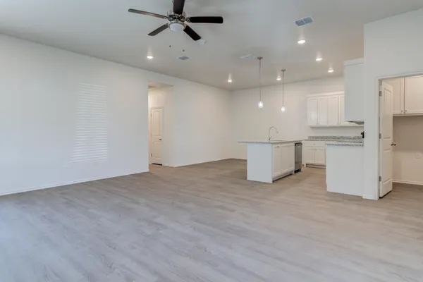 a view of a kitchen with a refrigerator and a microwave