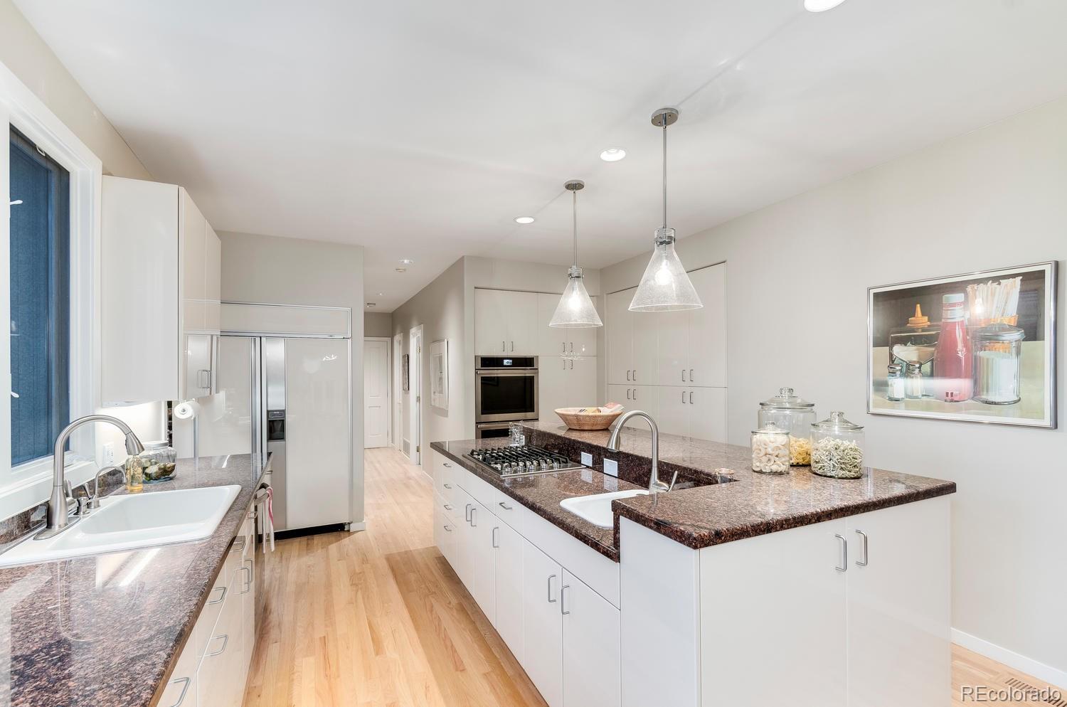 27 Hyde Park Circle Denver, CO 80209 - Photo 13 of 40 a kitchen with sink stove and refrigerator