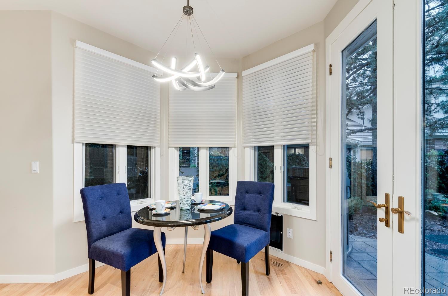 27 Hyde Park Circle Denver, CO 80209 - Photo 15 of 40 a view of a dining room with furniture a chandelier and wooden floor