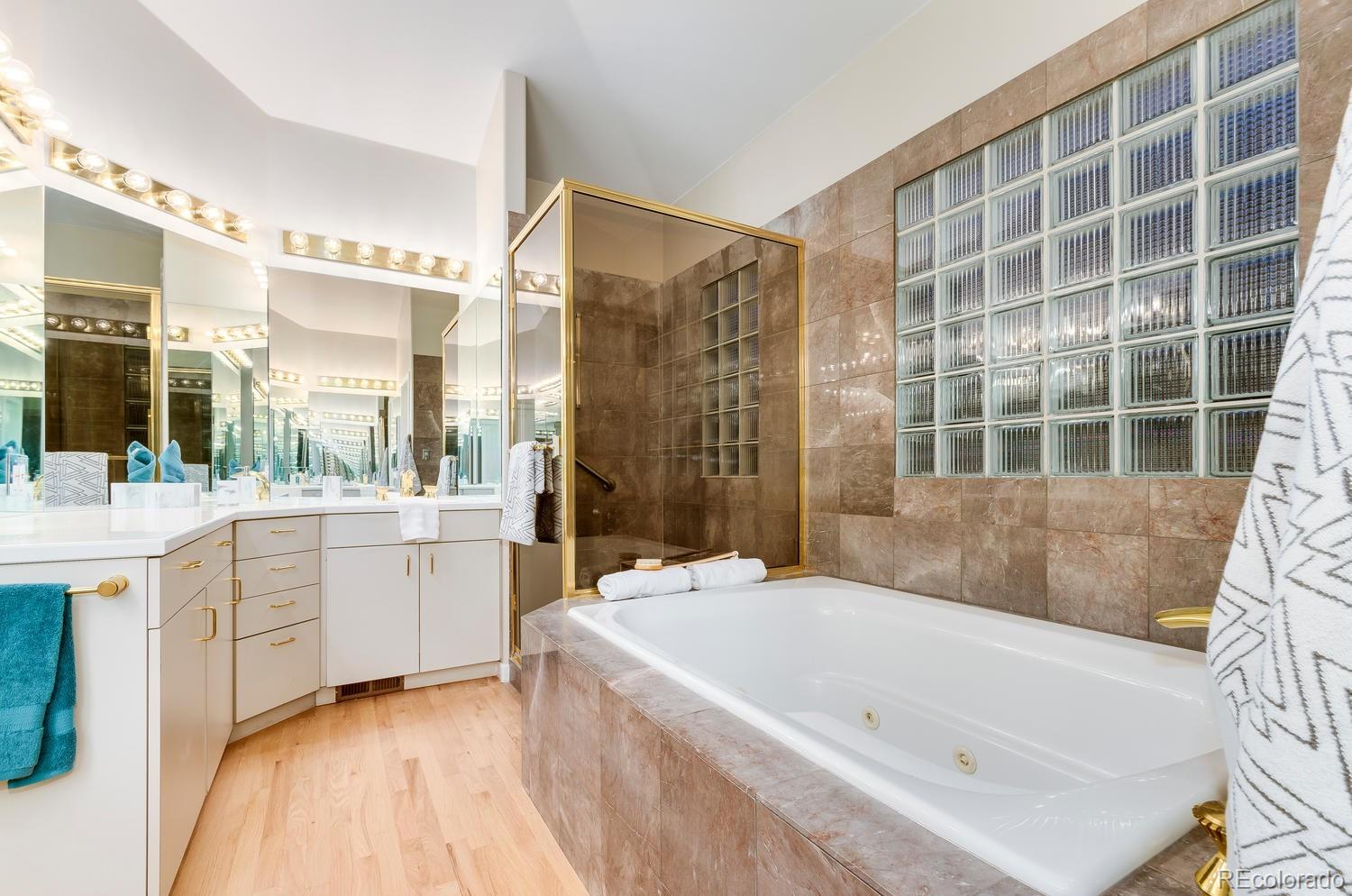 27 Hyde Park Circle Denver, CO 80209 - Photo 20 of 40 a bathroom with a granite countertop tub sink a shower and a mirror