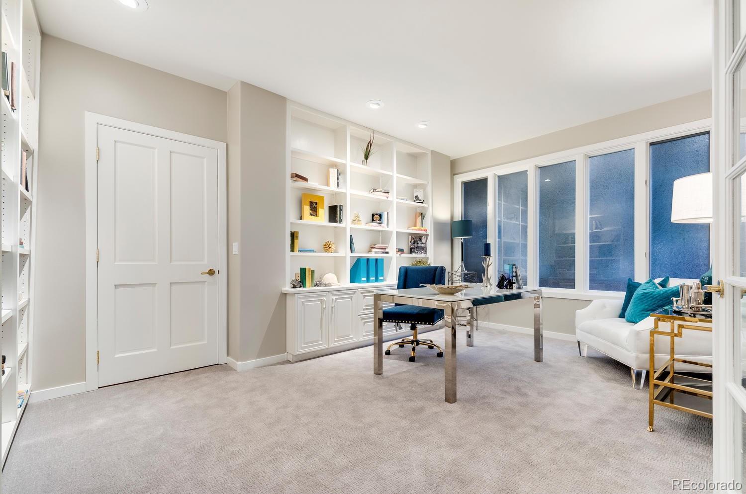 27 Hyde Park Circle Denver, CO 80209 - Photo 27 of 40 a living room with furniture and a bookshelf