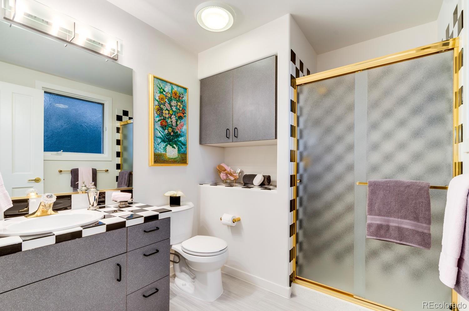 27 Hyde Park Circle Denver, CO 80209 - Photo 29 of 40 a bathroom with a sink a toilet and shower