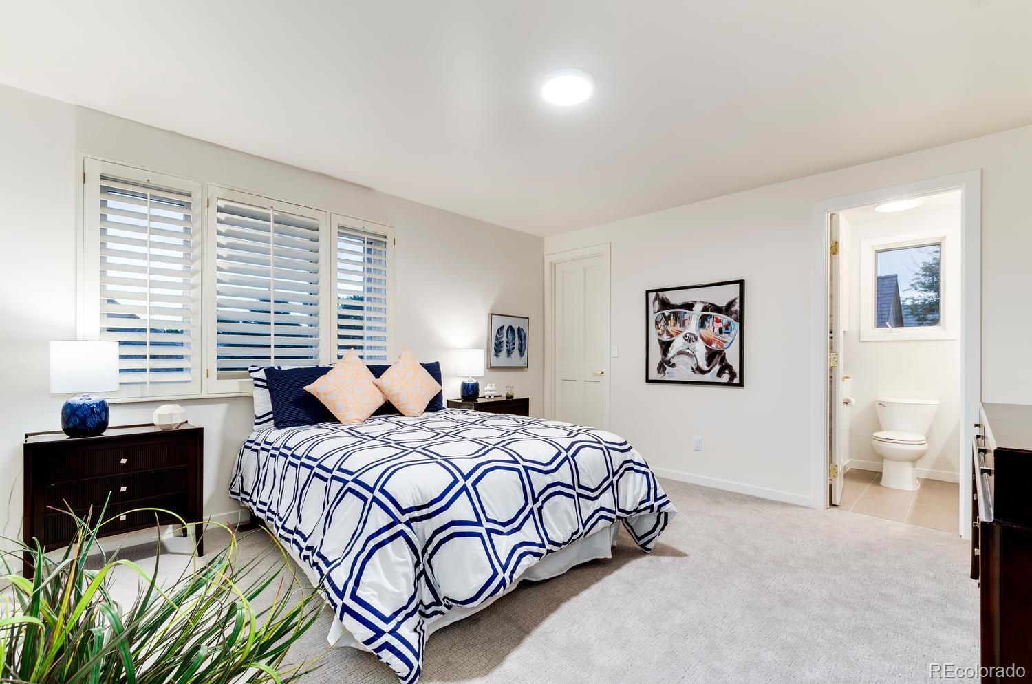 27 Hyde Park Circle Denver, CO 80209 - Photo 30 of 40 a bedroom with a bed and a table