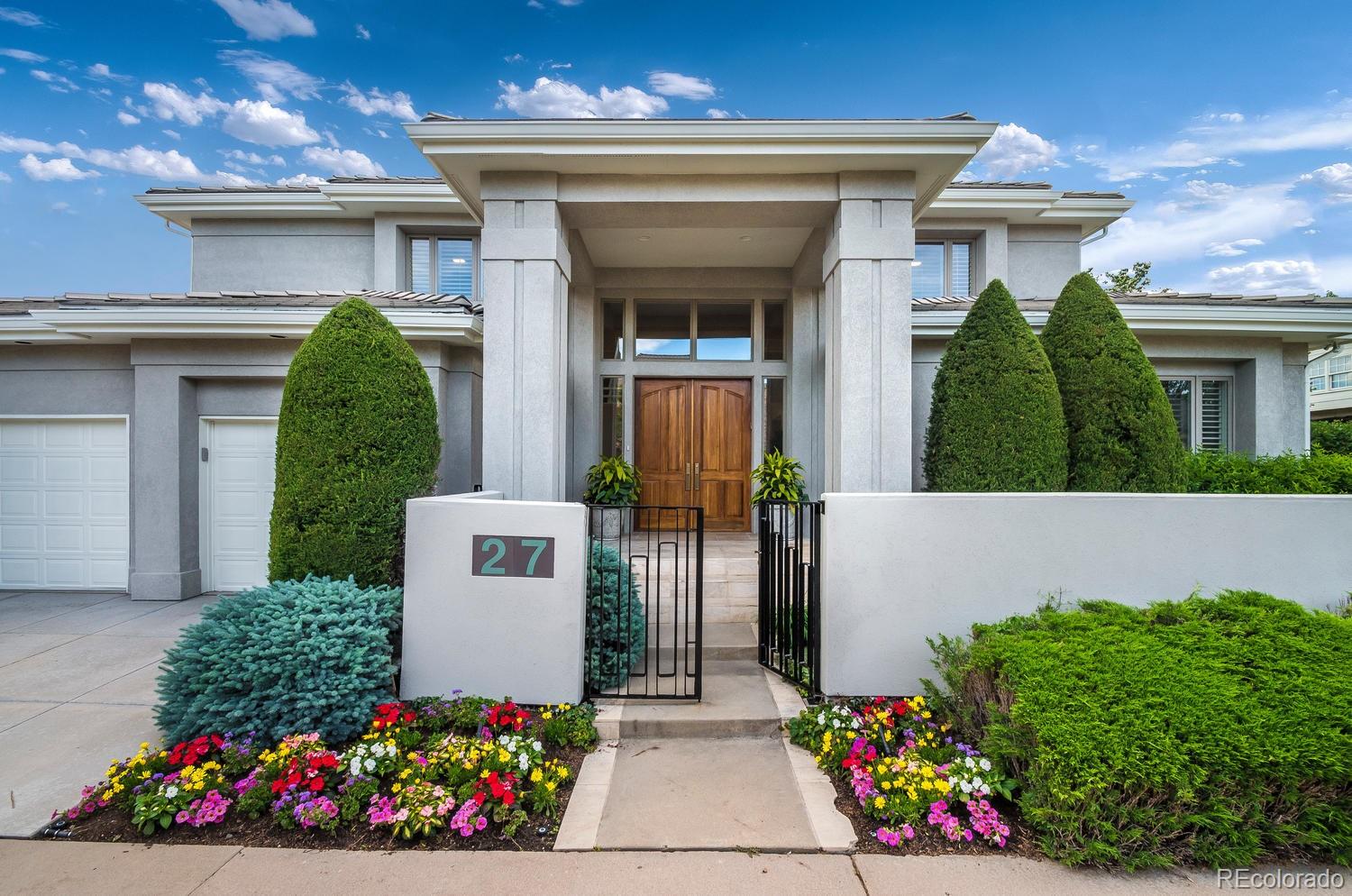 27 Hyde Park Circle Denver, CO 80209 - Photo 3 of 40 a front view of a house with lots of flowers around