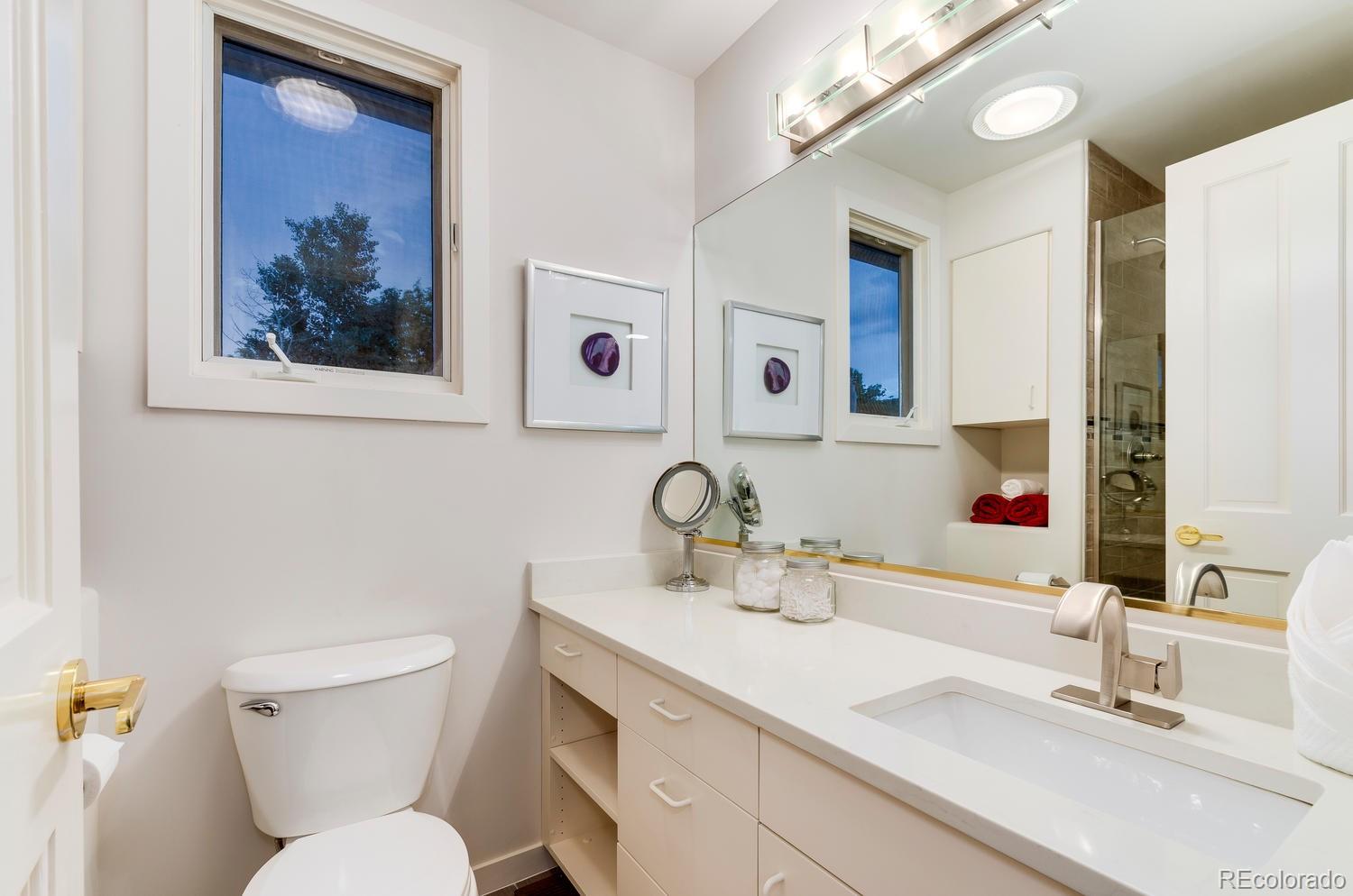 27 Hyde Park Circle Denver, CO 80209 - Photo 31 of 40 a bathroom with a toilet sink and mirror
