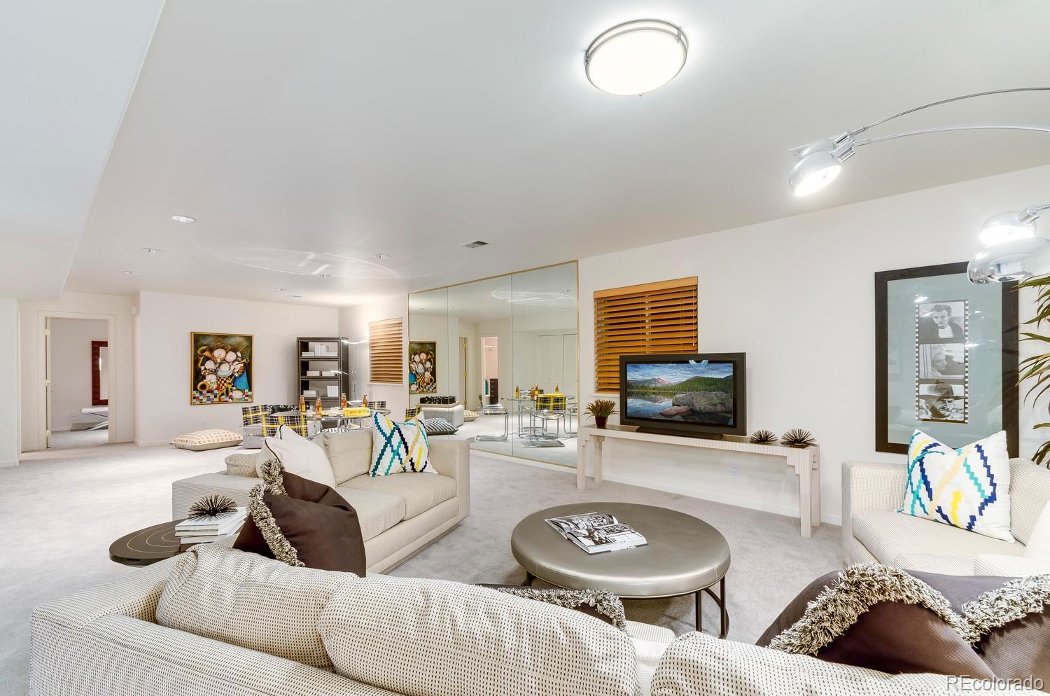 27 Hyde Park Circle Denver, CO 80209 - Photo 32 of 40 a living room with furniture and a flat screen tv